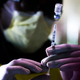 Pharmacy technicians prepare doses of the Pfizer-BioNTech vaccine at a mass COVID-19 vaccination event on January 30, 2021 in Denver, Colorado.